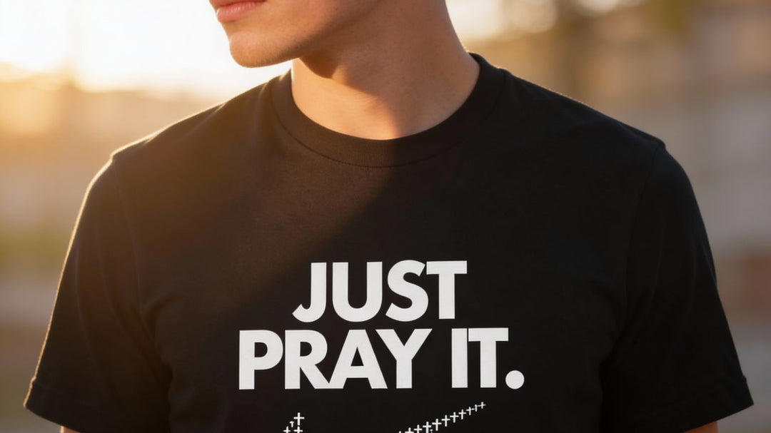 A person wears a black t-shirt with the words "JUST PRAY IT."